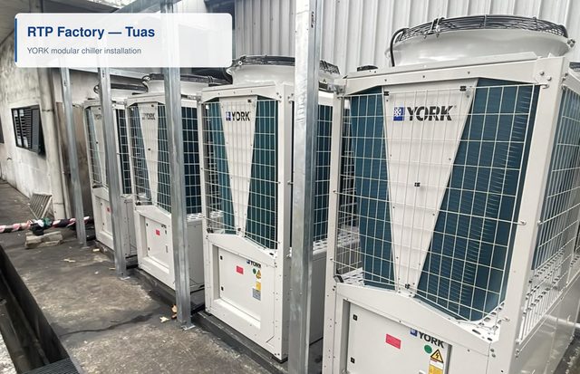 A row of YORK modular chiller units installed along an external wall at the RTP factory in Tuas.