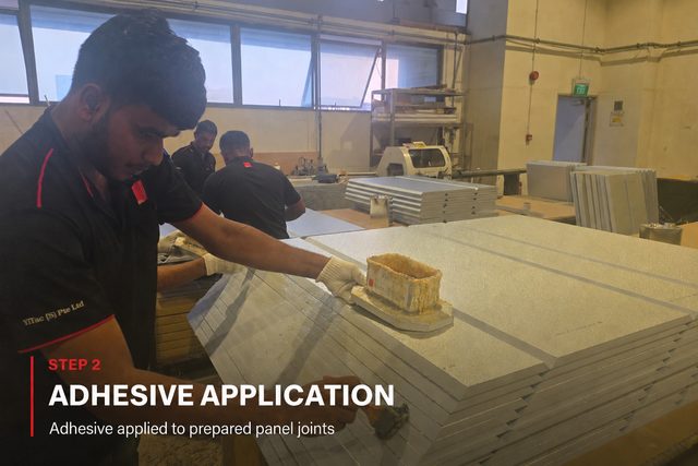 Step 2, adhesive application: a fabricator drawing an adhesive block along the grooved edge of a stacked PIR panel. Adhesive applied to prepared panel joints.