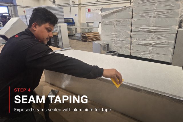 Step 4, seam taping: a fabricator pressing aluminium foil tape along the external corner seam of a formed duct section. Exposed seams sealed with aluminium foil tape.